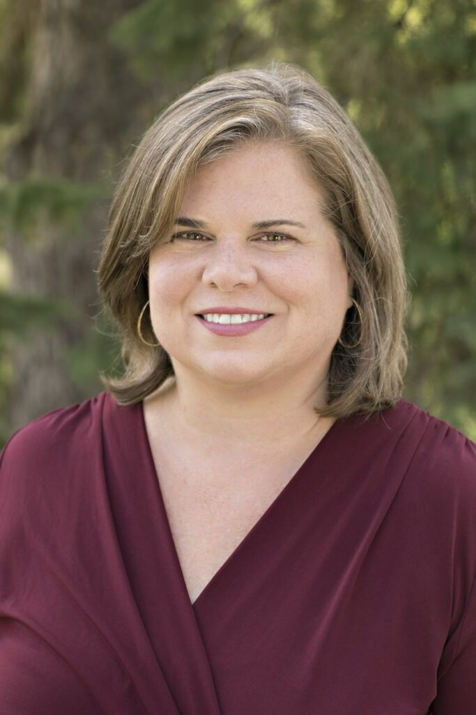 Julie Dirksen profile picture - she is looking at the camera and smiling, wearing a maroon sweater.