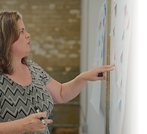 Julie Dirksen working at a whiteboard.