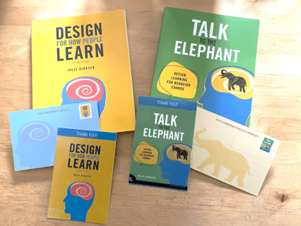 Copies of the books Design For How People Learn and Talk to the Elephant: Design Learning for Behavior Change with postcards that show the covers of both books.